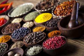 Spices on wooden bowl background 