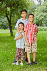 Fototapeta premium Portrait of three boys-brothers who stand together