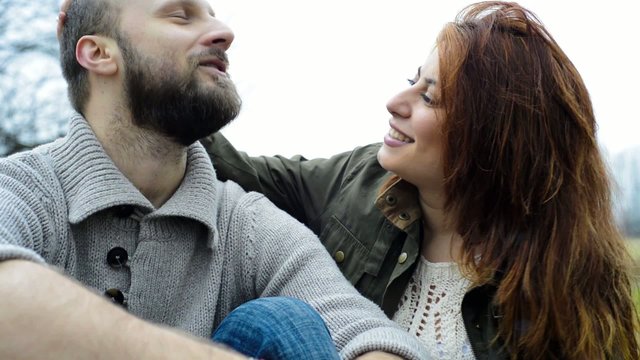 real couple in love embracing and kissing at the park outdoor i