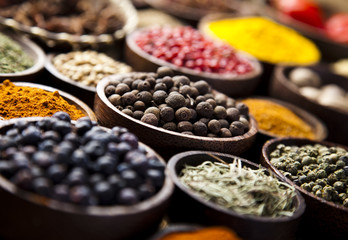Assortment of spices in wooden bowl background 