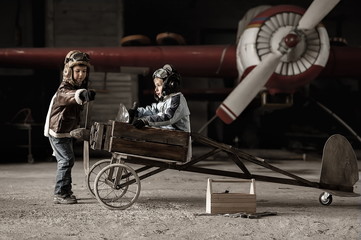 Young Aviators in a aircraft in a hangar with these planes