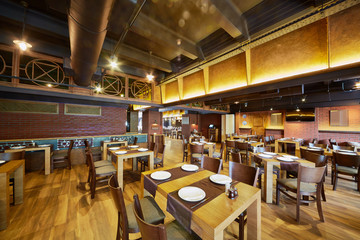 Fototapeta na wymiar Interior of cafe-bar with wooden furniture
