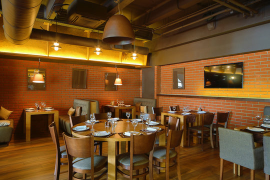 Restaurant hall with wooden round table in the center