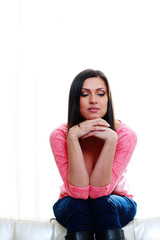 woman sitting on the sofa isolated on a white background