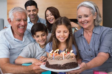 Extended family with cake in the living room