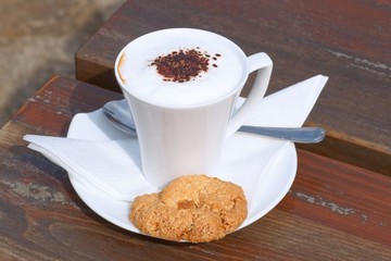 Coffee with milk in a cup and cake