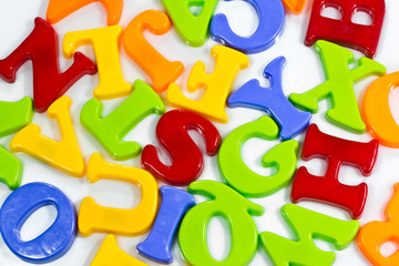 Fototapeta premium Plastic letters scattered on white background.