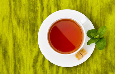 cup of tea on the green tablecloth