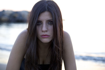 Woman with eyes full of tears destroyed by pain © fmarsicano
