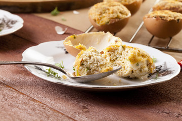 Baked eggs, stuffed with ham and parsley