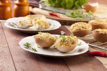 Baked eggs, stuffed with ham and parsley