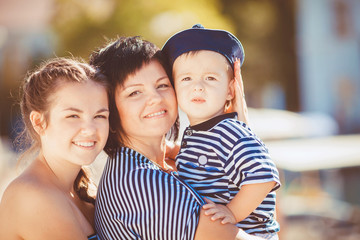 Mom, daughter and son rest in the summer on the beach