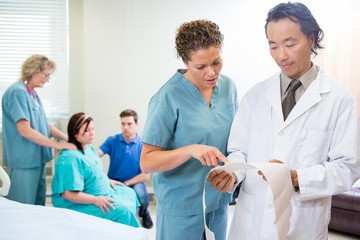 Fototapeta premium Medical Team with Fetal Monitor Report