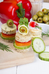 Fototapeta na wymiar finger foods: bread, peppers, cucumber, cheese and olives