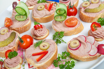 party platter with sandwiches with pate and vegetables