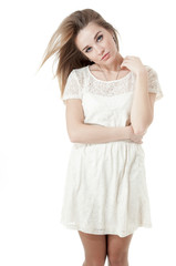 Beautiful girl dressed in a short white dress, isolated on white