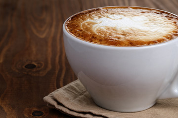 freshly made cup of cappuccino with abstract latte art