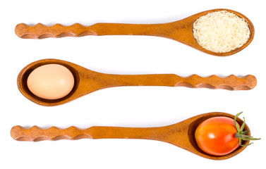 Rice, egg and tomato on a wooden spoon.