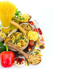 Variety of uncooked pasta and vegetables