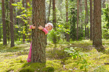 Little girl walking in the forest