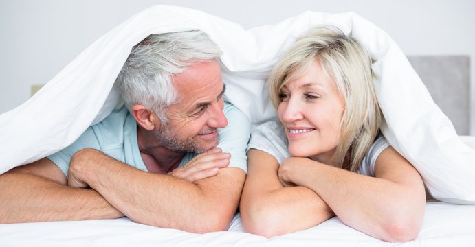 Close-up of a mature couple lying in bed