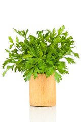 Parsley in a wooden pot over a white background