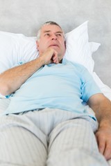 Thoughtful senior man in bed