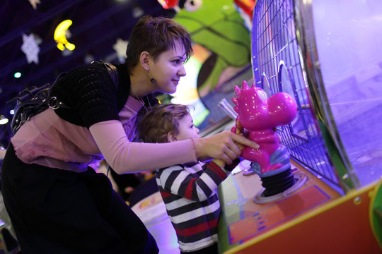 Mother with son playing in amusement