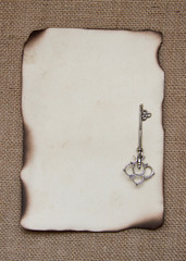 Burned paper card with silver key