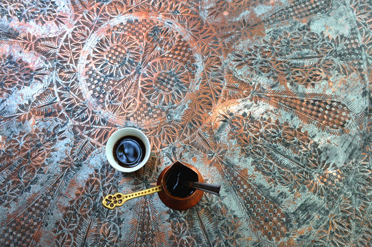 traditional turkish cup of coffee on ornamented brass table