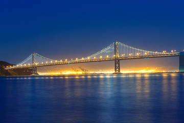 Fototapeta na wymiar San Francisco Bay Bridge at sunset from Pier 7 California