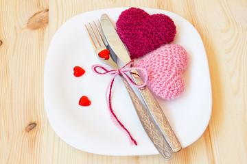 table setting for valentine's day with knitted toys