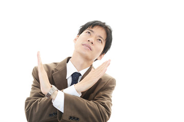 禁止の意思表示をするビジネスマン