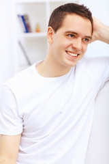 Young man at home with a book