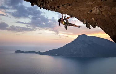 Poster Im Rahmen Young female rock climber at sunset, Kalymnos Island, Greece © Andrey Bandurenko
