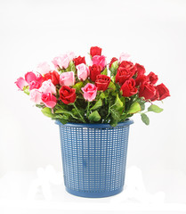 Colorful roses in basket isolated on white
