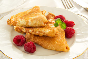 Delicious pancakes with berries and honey