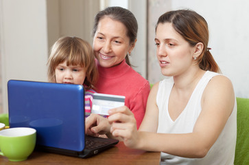 Fototapeta na wymiar Happy family of three generations shopping online