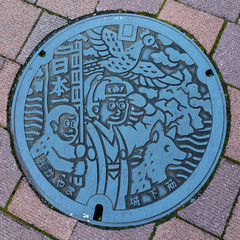 Naklejka premium Momotaro character on a Manhole