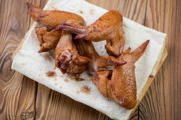 Above view of smoked chicken wings on pita bread