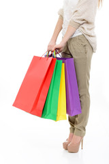 shopping girl, young woman on high heels with colored shopping b