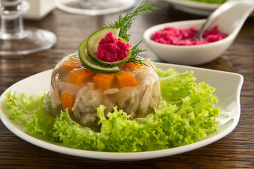 meat jelly with vegetables and sauce.