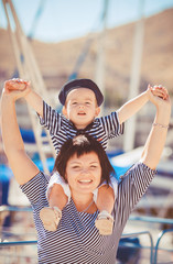 Beautiful young family of two walking along wooden jetty