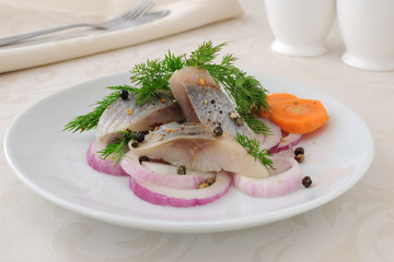 Slices of salted herring with onions and spices