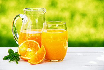 A jug and glass of fresh orange juice