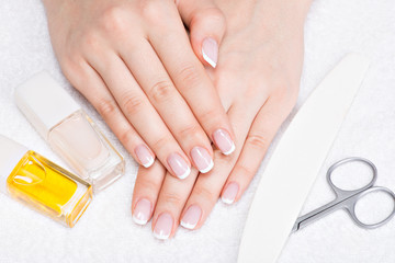 Woman in a nail salon receiving manicure