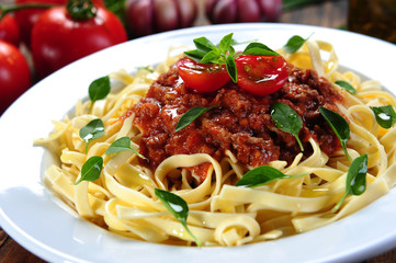 Noodles with bolognese sauce and herbs