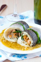 Fish rolls of dorado fillet stuffed shrimp and spinach, onion