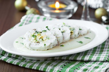 Roulade roll of white fish fillet cod stuffed with egg, sauce