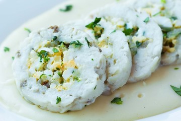 Roulade roll of white fish fillet cod stuffed with egg, sauce